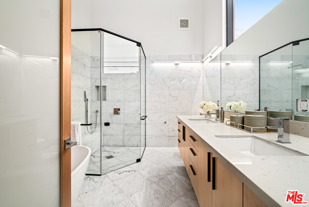 11519 Mississippi Avenue Los Angeles, CA 90025 - Photo 35 of 45 a large bathroom with a double vanity sink a mirror and a shower