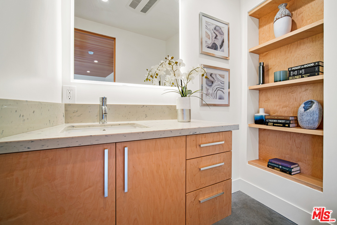 11519 Mississippi Avenue Los Angeles, CA 90025 - Photo 43 of 45 a bathroom with a sink a vanity and a mirror
