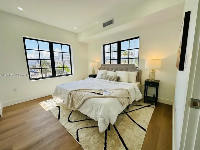 a bedroom with a bed window and a wall painting