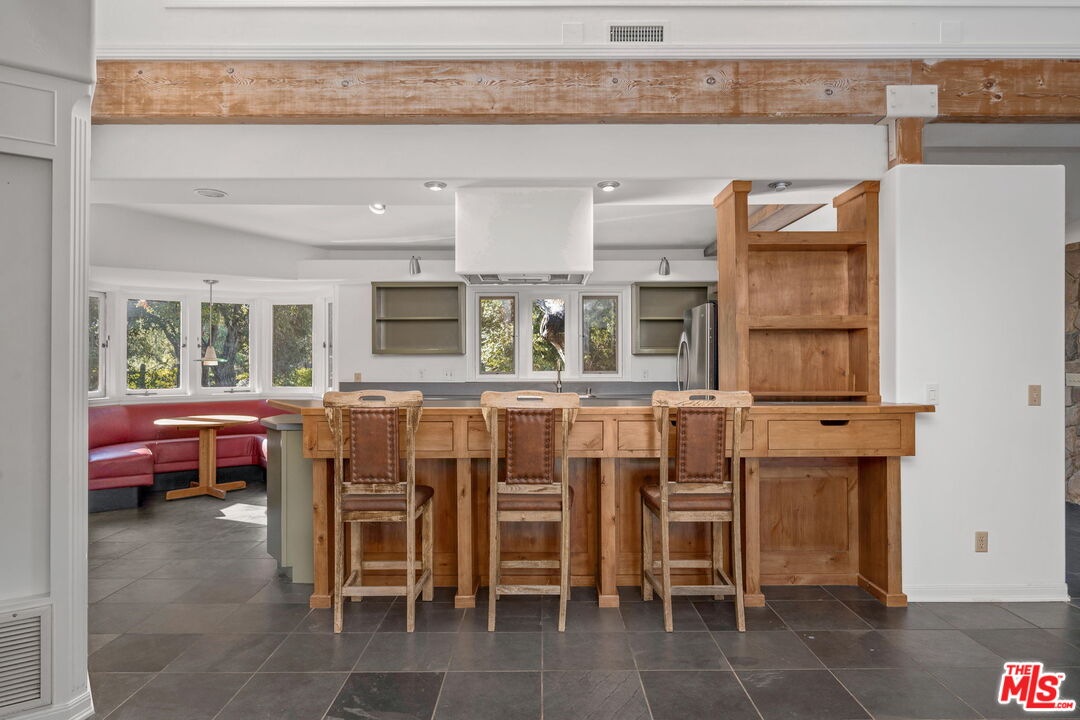 310 McKee Street Ojai, CA 93023 - Photo 14 of 33 a dining room with a wooden table and chairs