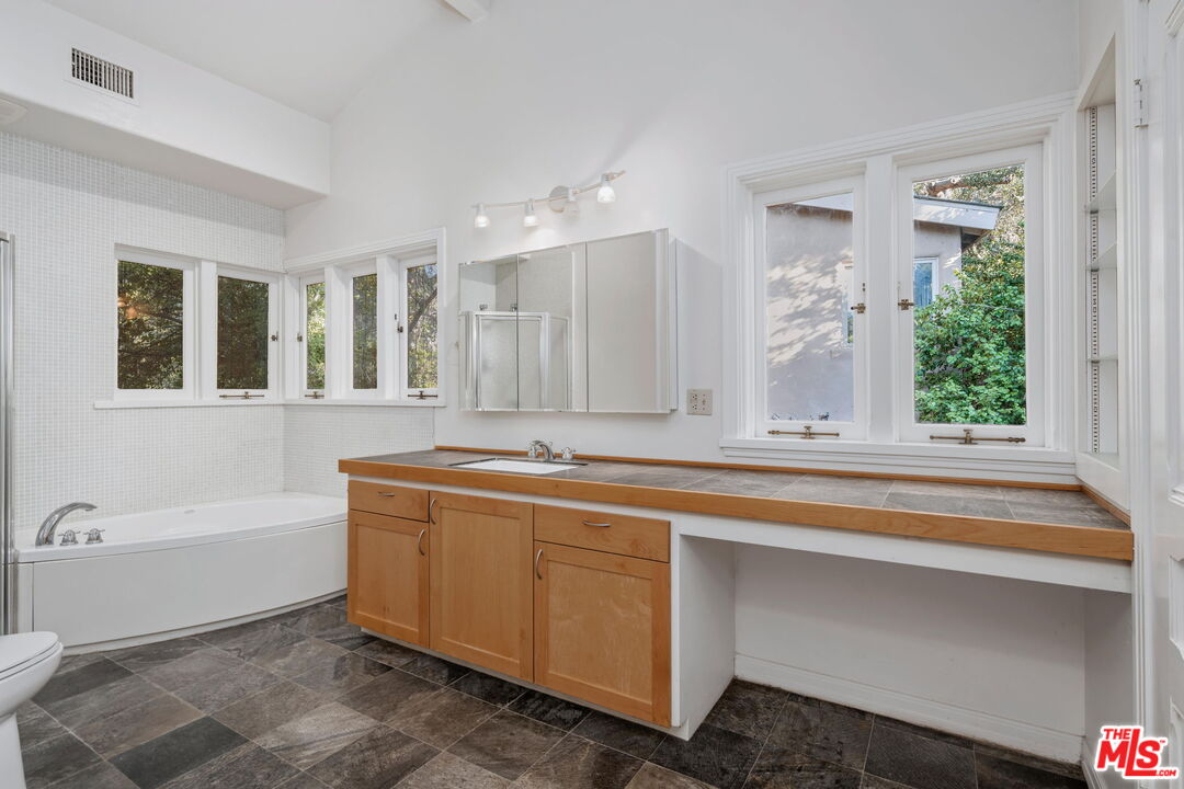 310 McKee Street Ojai, CA 93023 - Photo 20 of 33 a bathroom with a tub sink and mirror