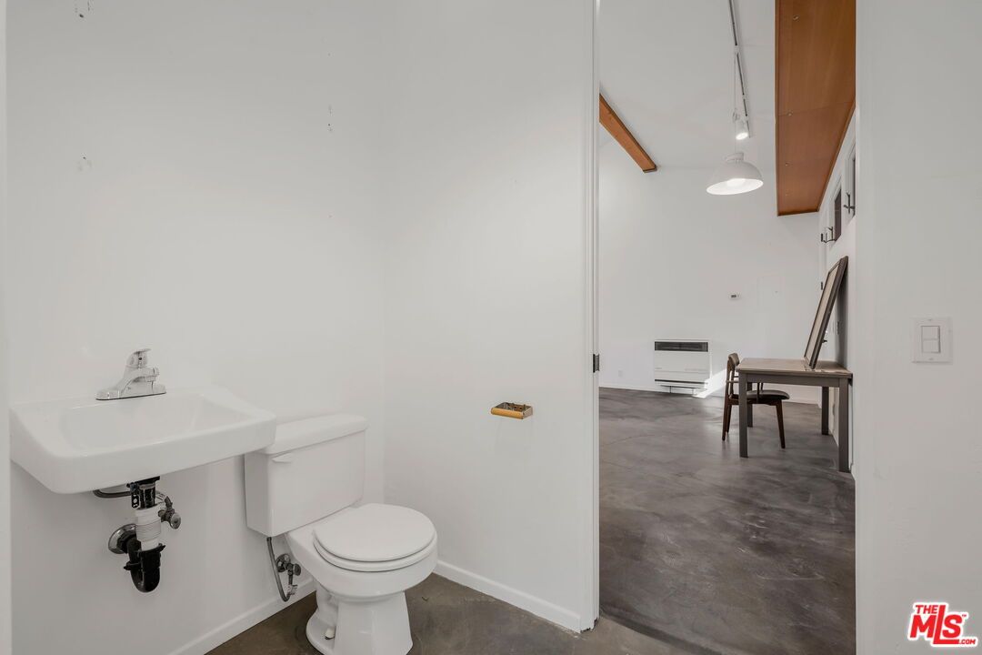 310 McKee Street Ojai, CA 93023 - Photo 29 of 33 a bathroom with a toilet a sink and a mirror