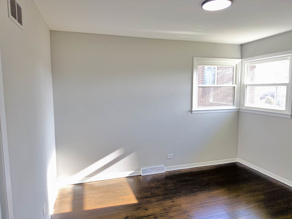 5633 Murray Drive Berkeley, IL 60163 - Photo 11 of 17 an empty room with wooden floor and windows