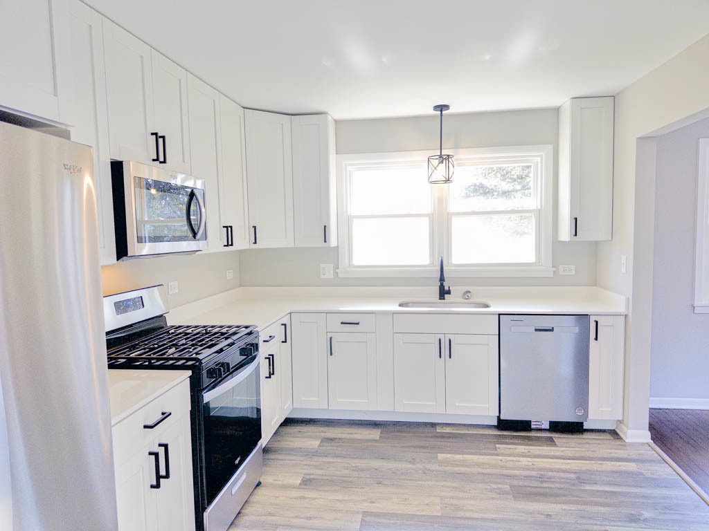 5633 Murray Drive Berkeley, IL 60163 - Photo 3 of 17 a kitchen with stainless steel appliances granite countertop a sink stove and refrigerator