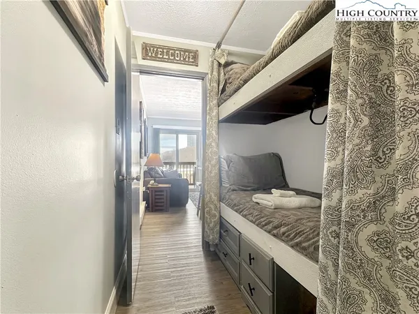 a view of a balcony with a chair and wooden floor