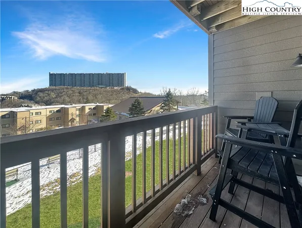 a view of a balcony with chairs and potted plants