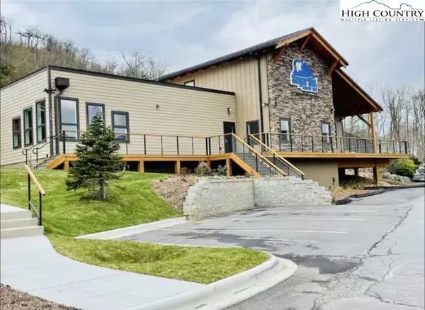 a room with lots of white furniture and a window