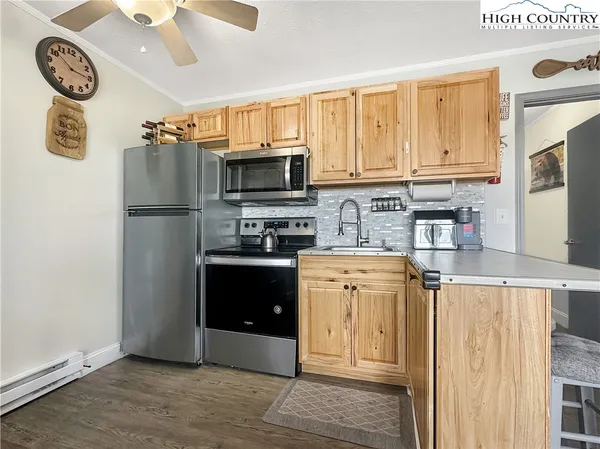 a kitchen with a refrigerator a stove a microwave and wooden floor