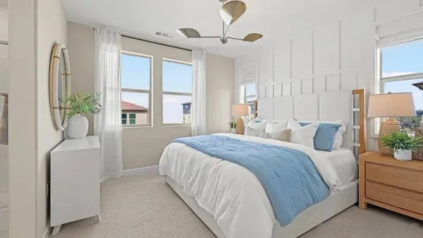 a bedroom with a bed and a potted plant