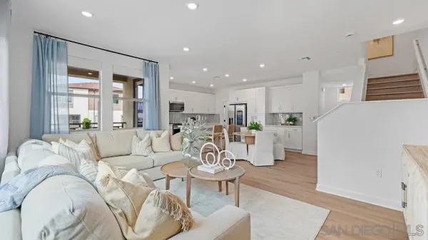 a living room with furniture wooden floor and a large window