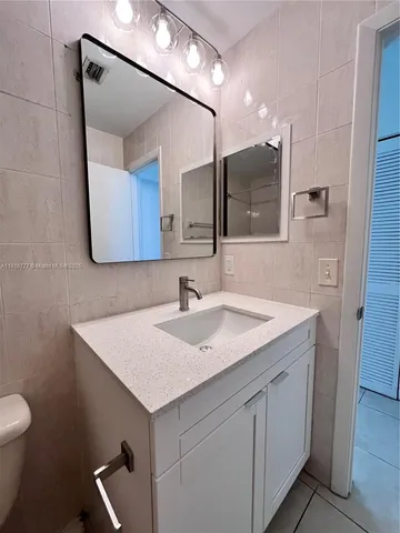 a bathroom with a sink a vanity and a mirror