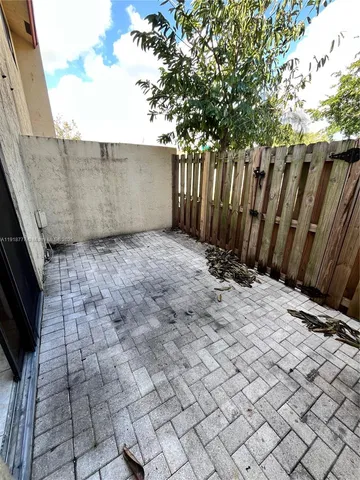 a view of backyard with wooden fence