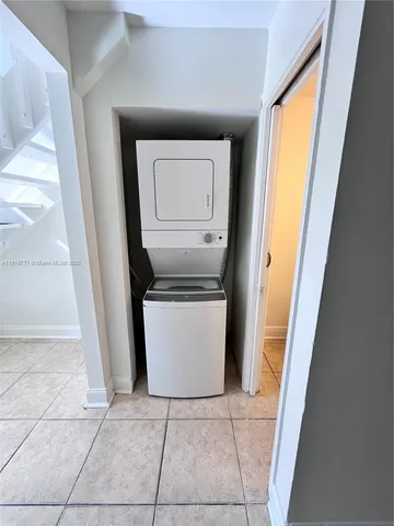 a utility room with window and washer