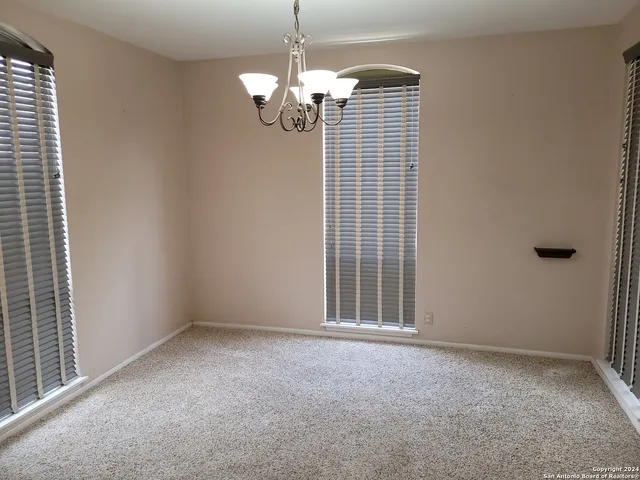 a view of a chandelier fan in a room