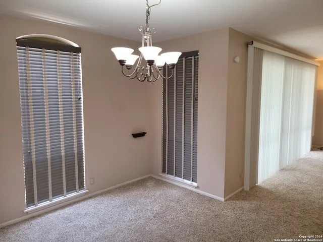 a view of an empty room with a chandelier