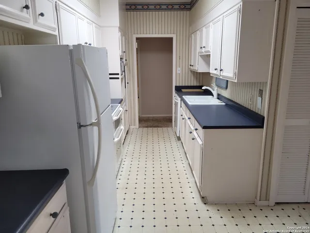 a view of a livingroom with a ceiling fan and window