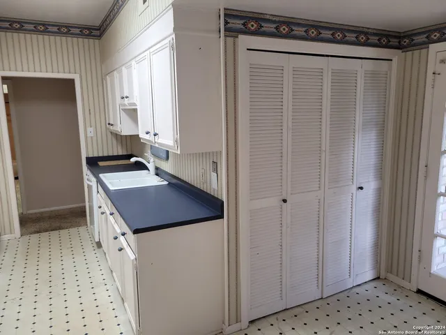 a bathroom with a shower a toilet and a sink