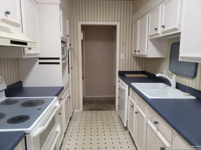 a bed room with a bed and a chandelier