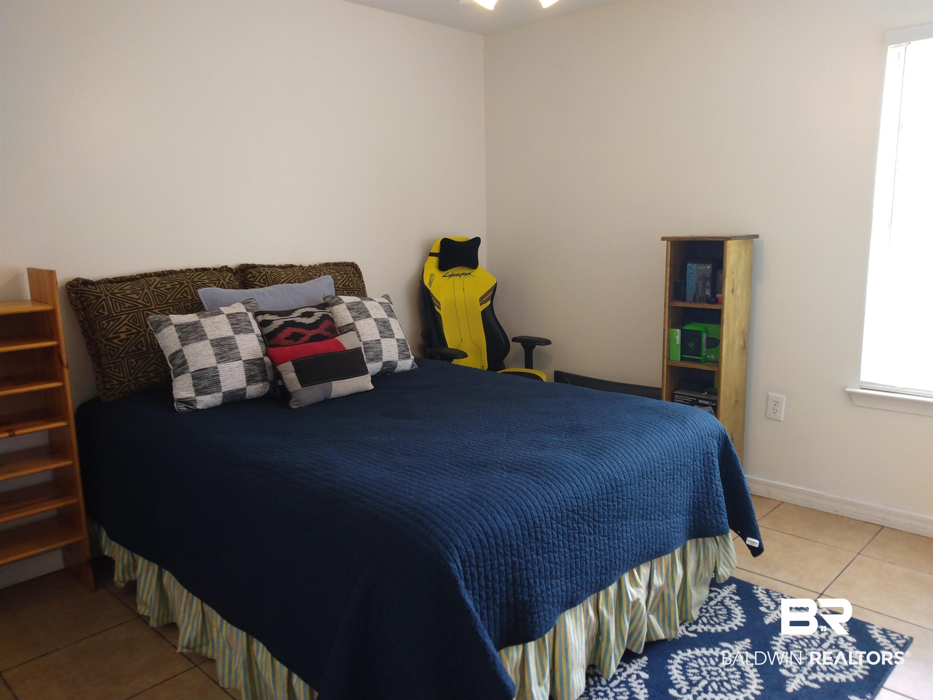 431 Hamilton Boulevard Foley, AL 36535 - Photo 16 of 30 Guest bedroom with light tile patterned flooring.