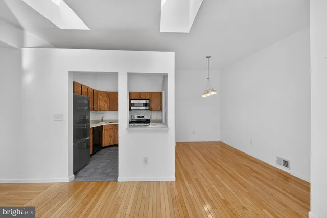 a kitchen view with wooden floor and a sink