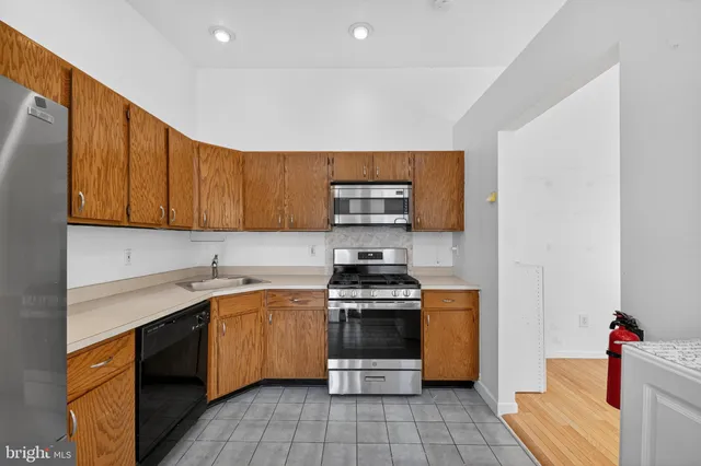 a kitchen with a sink stove and microwave