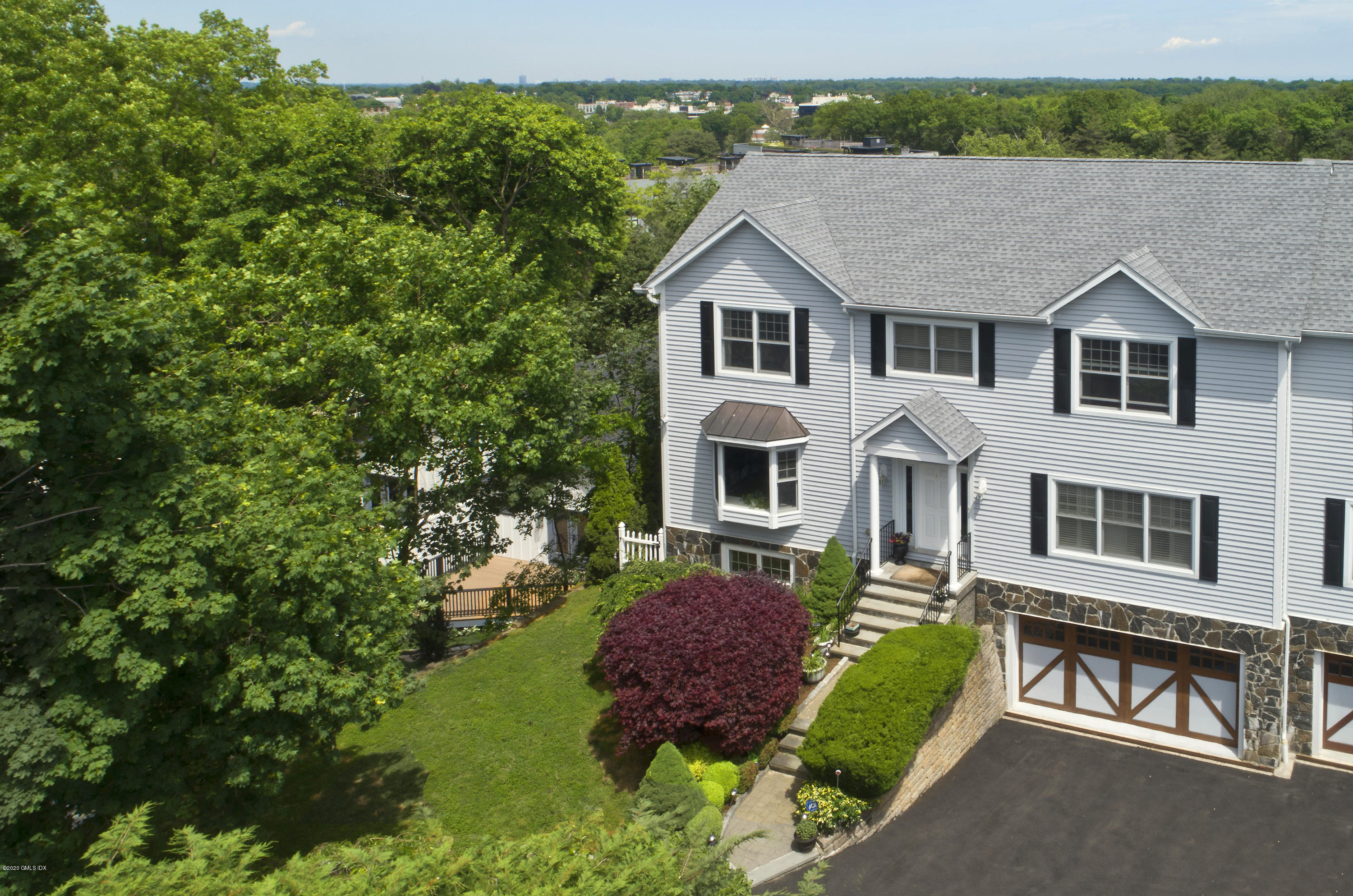 8 View Street, Unit 5 Greenwich, CT 06830 - Photo 1 of 30 a view of a white house with a yard plants and large tree