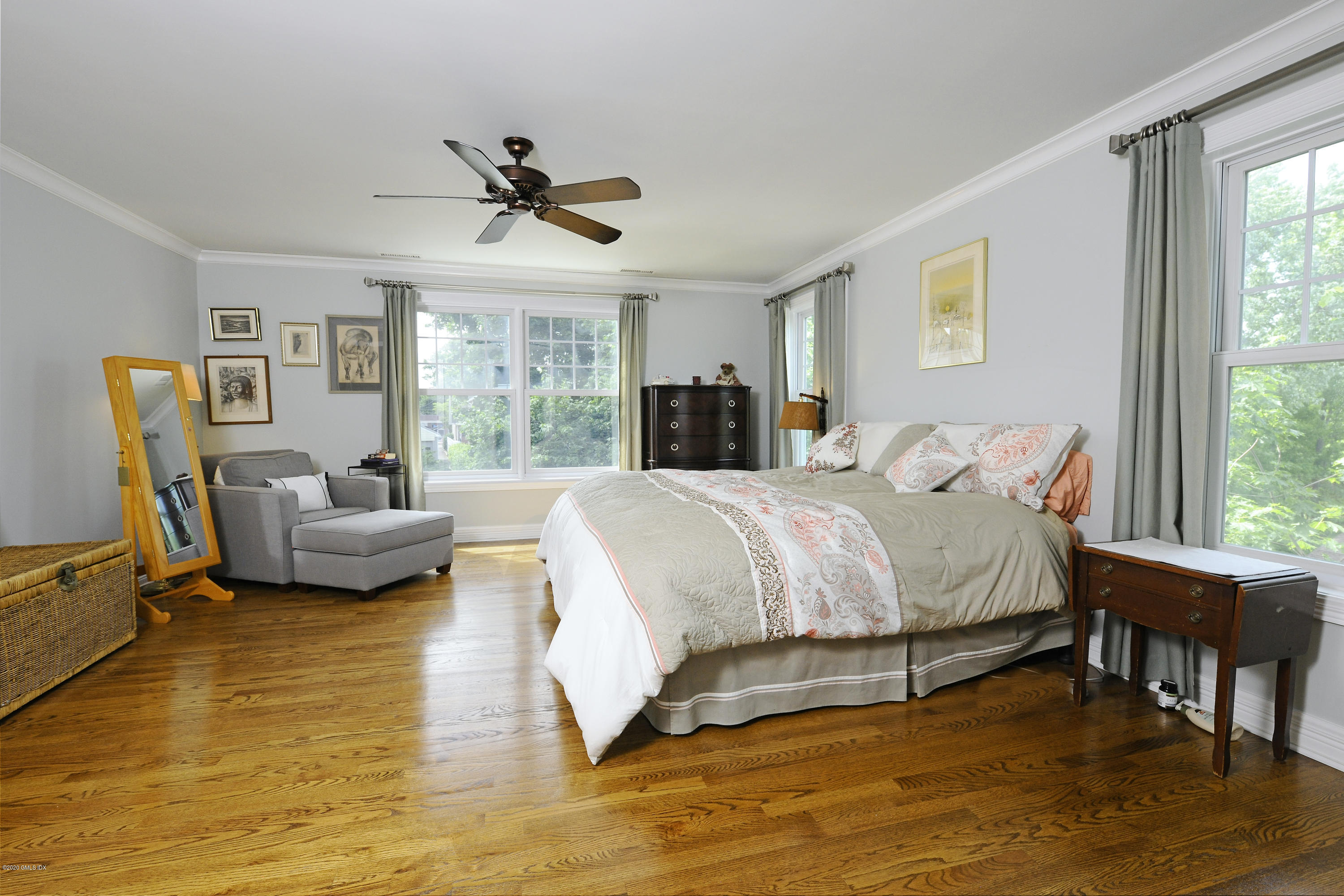 8 View Street, Unit 5 Greenwich, CT 06830 - Photo 19 of 30 a spacious bedroom with a bed a couch and a large window