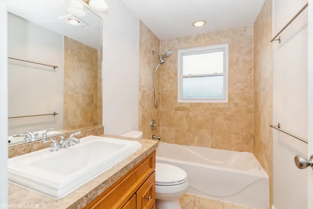 a bathroom with a sink toilet tub and shower