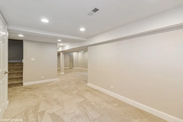 an empty room with closet and windows