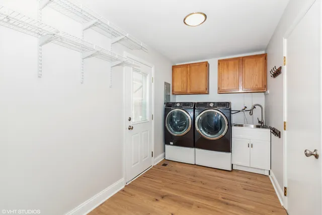 a view of a storage and utility room with washer and dryer