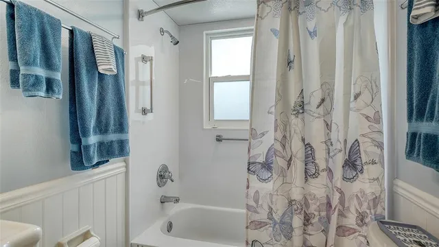 a bathroom with a bathtub and a shower
