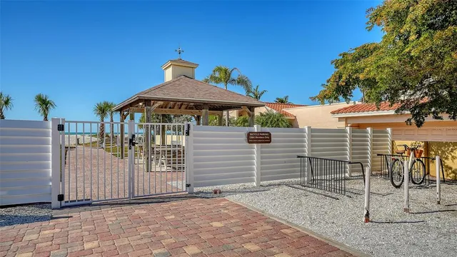 a view of a porch with a table and chairs under an umbrella