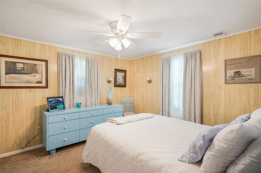 2220 Coon Point Crystal River, FL 34429 - Photo 11 of 58 a bedroom with a bed and a chandelier