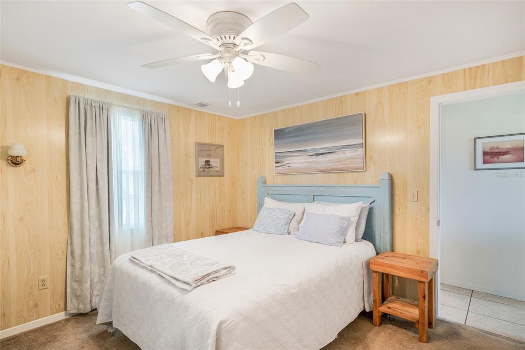 2220 Coon Point Crystal River, FL 34429 - Photo 12 of 58 a bedroom with a bed and a chandelier