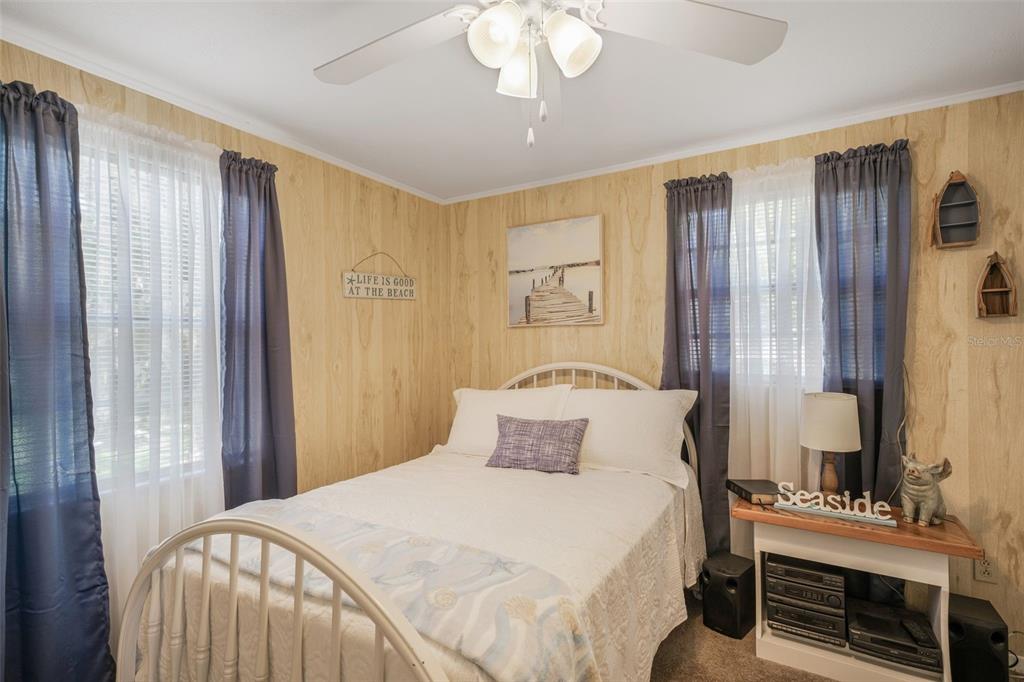 2220 Coon Point Crystal River, FL 34429 - Photo 14 of 58 a bedroom with a bed and a chandelier