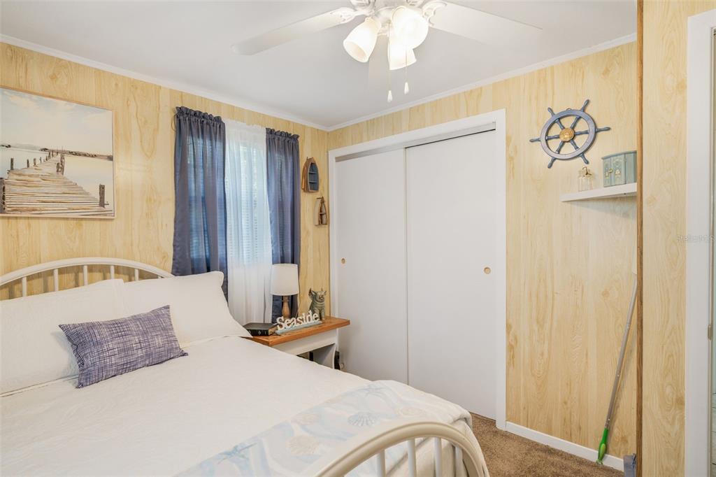 2220 Coon Point Crystal River, FL 34429 - Photo 15 of 58 a bedroom with a large bed and a chandelier