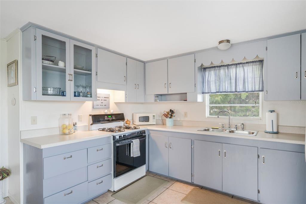 2220 Coon Point Crystal River, FL 34429 - Photo 33 of 58 a kitchen with cabinets appliances a sink and a window