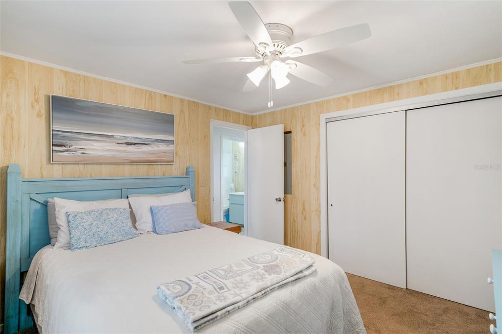 2220 Coon Point Crystal River, FL 34429 - Photo 36 of 58 a bedroom with a large bed and a chandelier