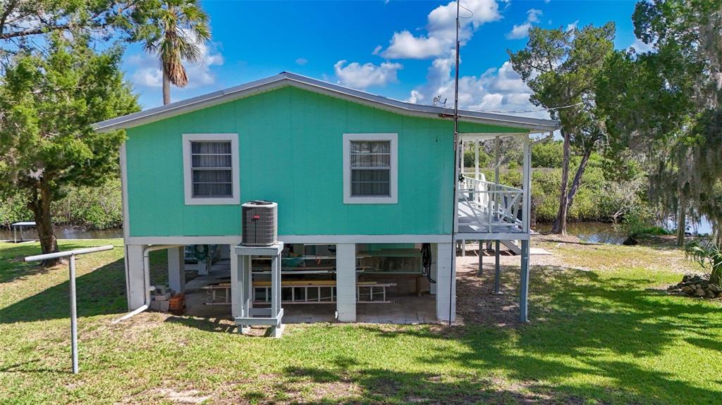 2220 Coon Point Crystal River, FL 34429 - Photo 37 of 58 a view of a chairs and table in backyard of the house