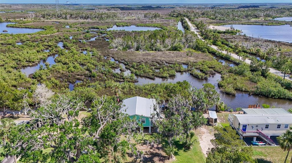 2220 Coon Point Crystal River, FL 34429 - Photo 49 of 58 an aerial view of a house with a yard and lake view