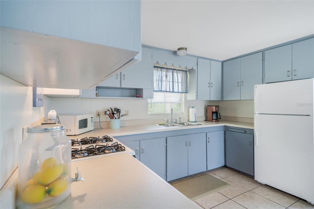 2220 Coon Point Crystal River, FL 34429 - Photo 5 of 58 a kitchen with a sink a stove and refrigerator