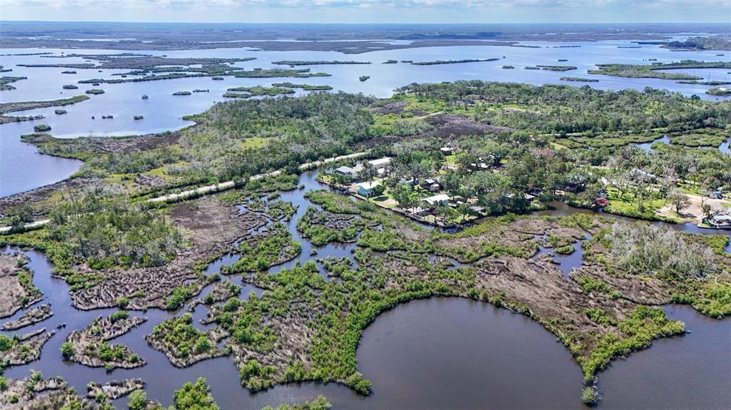 2220 Coon Point Crystal River, FL 34429 - Photo 56 of 58 an aerial view of a house with a yard and lake view