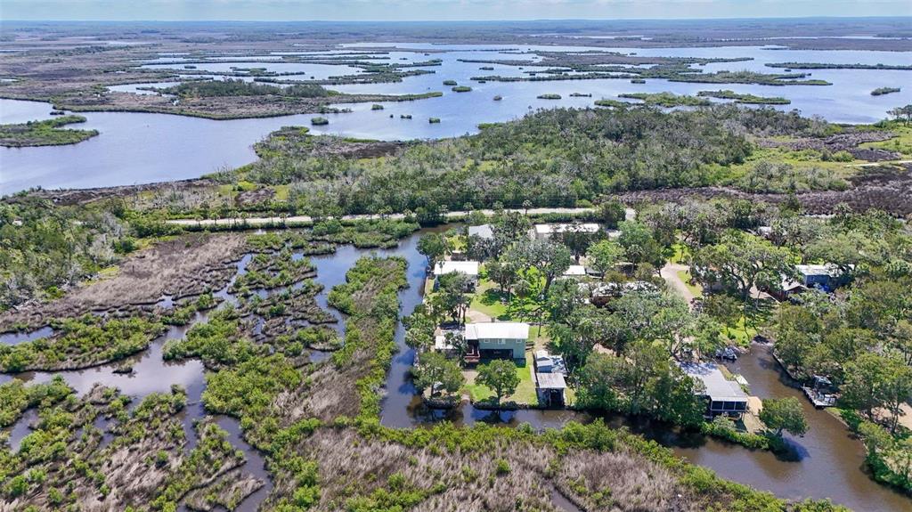 2220 Coon Point Crystal River, FL 34429 - Photo 57 of 58 an aerial view of a house with a yard and lake view