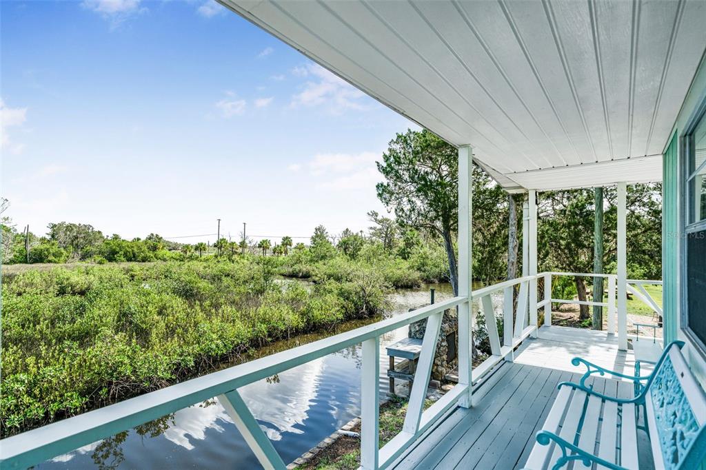 2220 Coon Point Crystal River, FL 34429 - Photo 8 of 58 a view of a balcony with wooden floor and fence