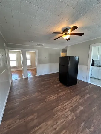 a view of empty room with window and wooden floor