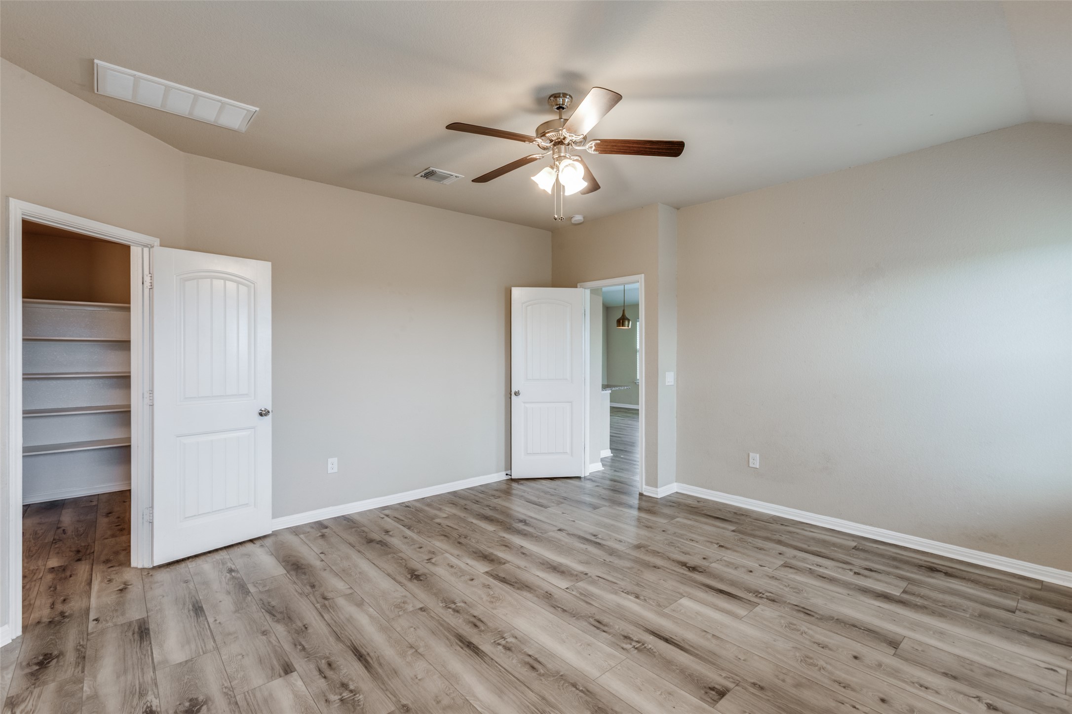 2909 Centrum Drive Austin, TX 78754 - Photo 19 of 30 This room features wood-look flooring, a ceiling fan with integrated lighting, and neutral wall paint