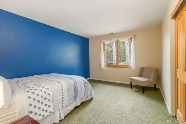 a bedroom with a bed and a chair