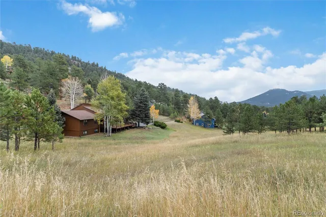 a view of patio with dining table and chairs with wooden floor