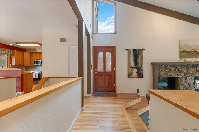 a view of living room kitchen with granite countertop furniture and fireplace