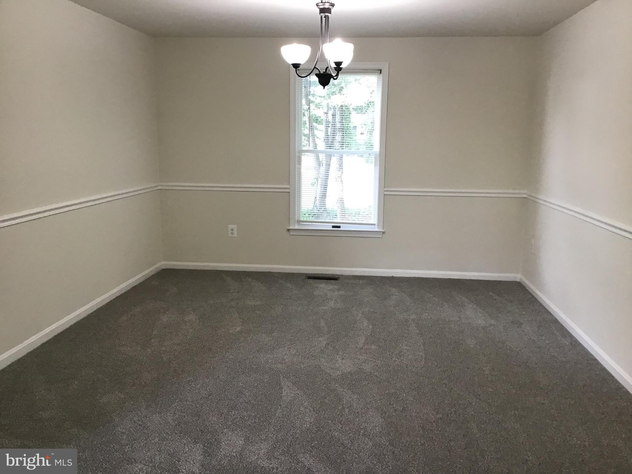 2001 Powder Horn Drive Fort Washington, MD 20744 - Photo 9 of 26 an empty room with a windows and chandelier